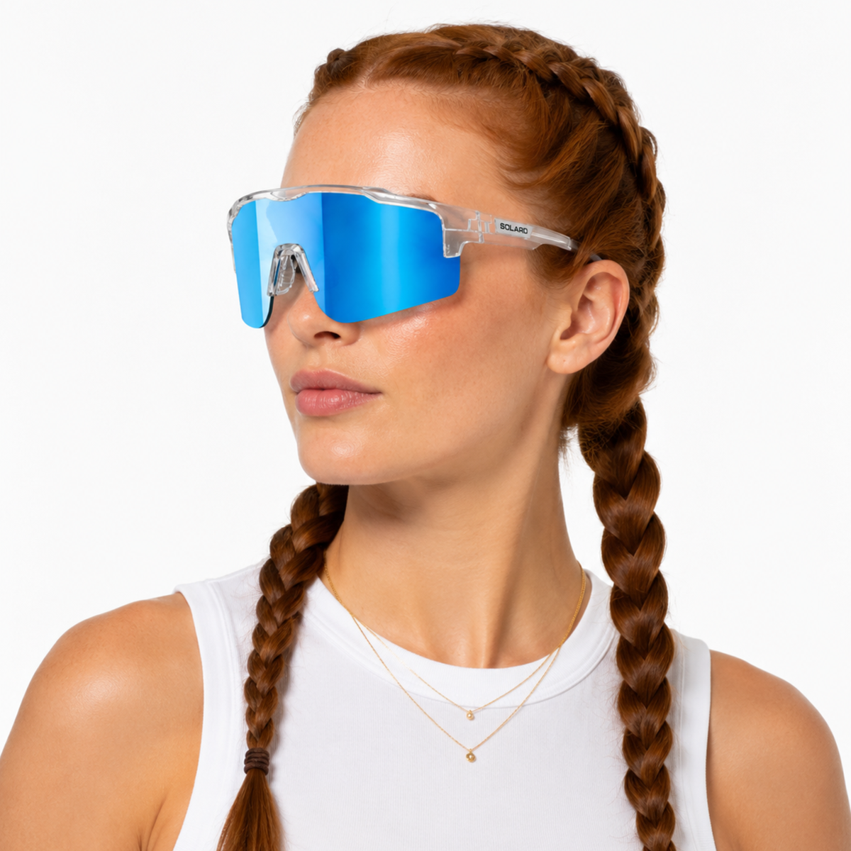 Woman wearing blue solaro shades mirrored sports sunglasses with a white background.