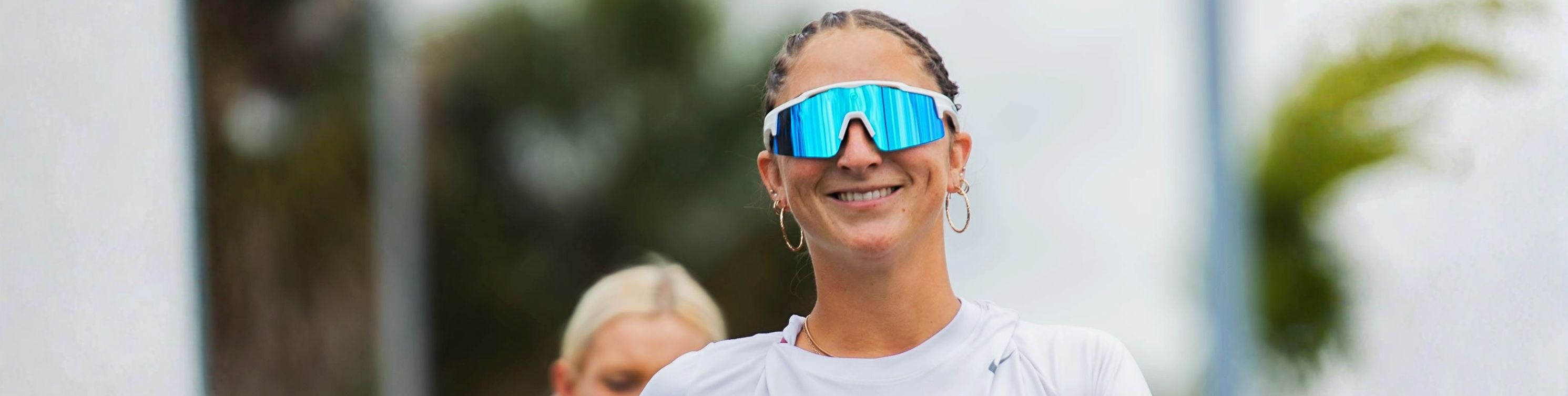 A softball athlete wearing Solaro Shades softball sunglasses, designed by women, for women.