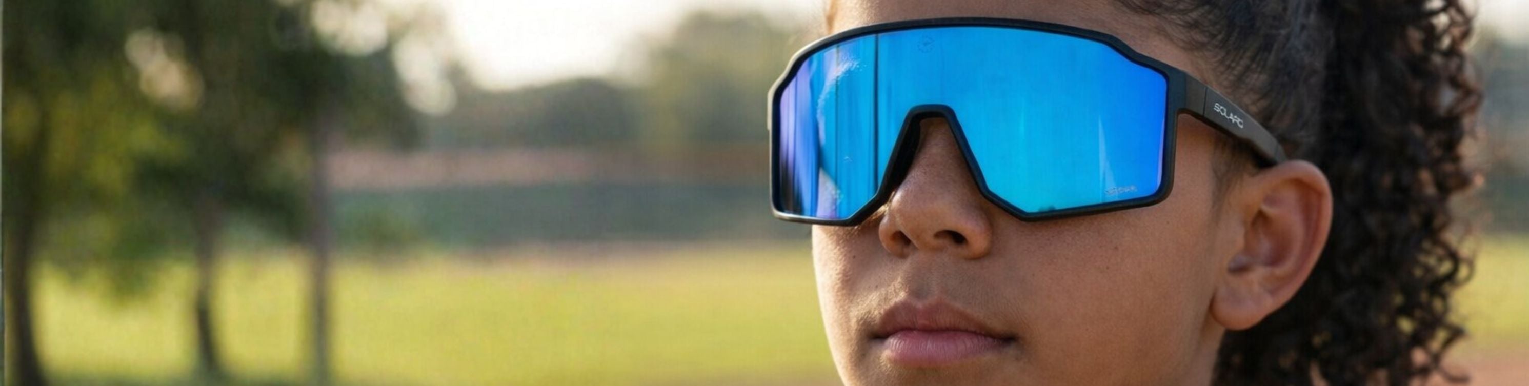 Young athlete wearing Solaro Shades youth sports sunglasses for softball.