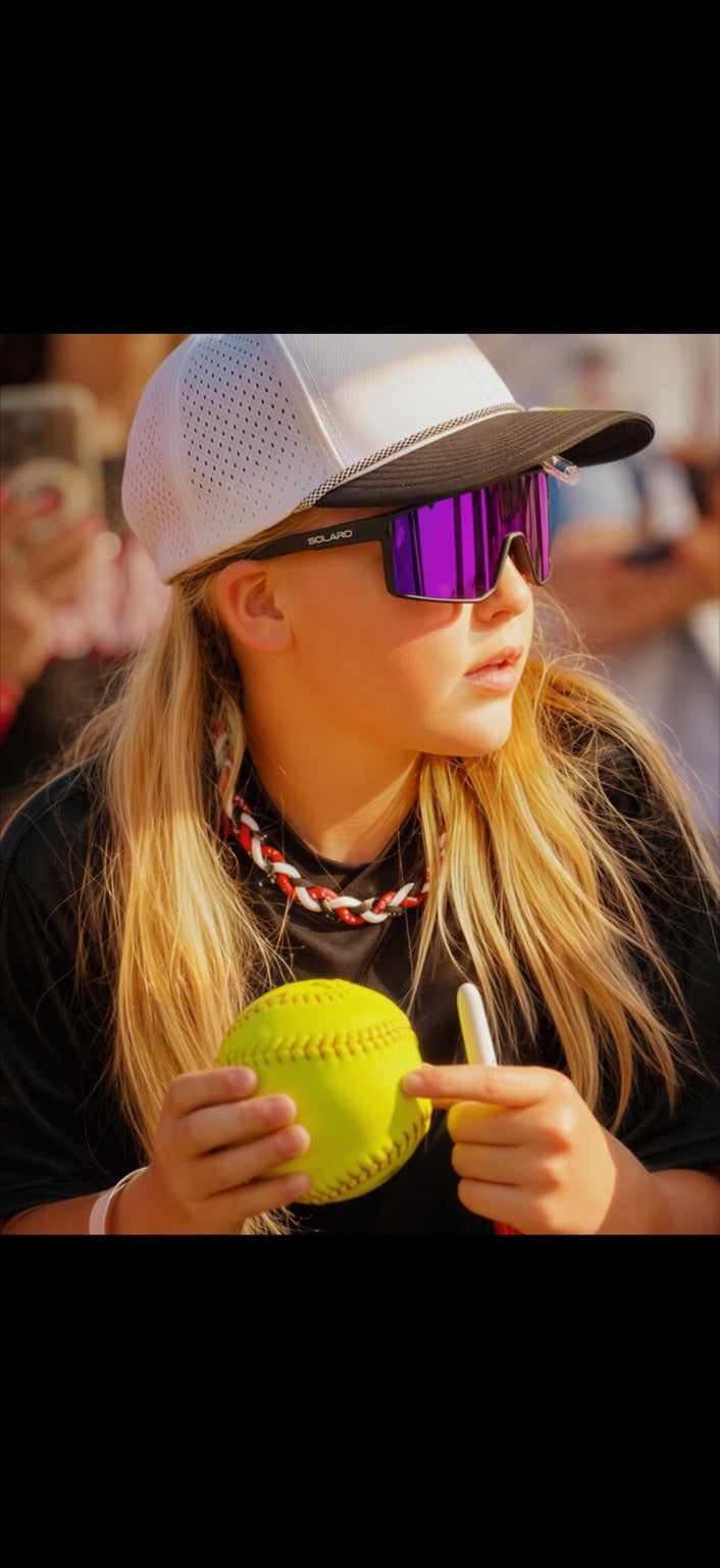 Young softball player wearing purple Solaro sunglasses