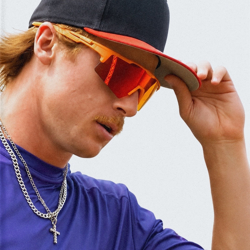 Male athlete wearing orange baseball sunglasses by Solaro Shades, the #1 brand for baseball sunglasses and sports sunglasses.