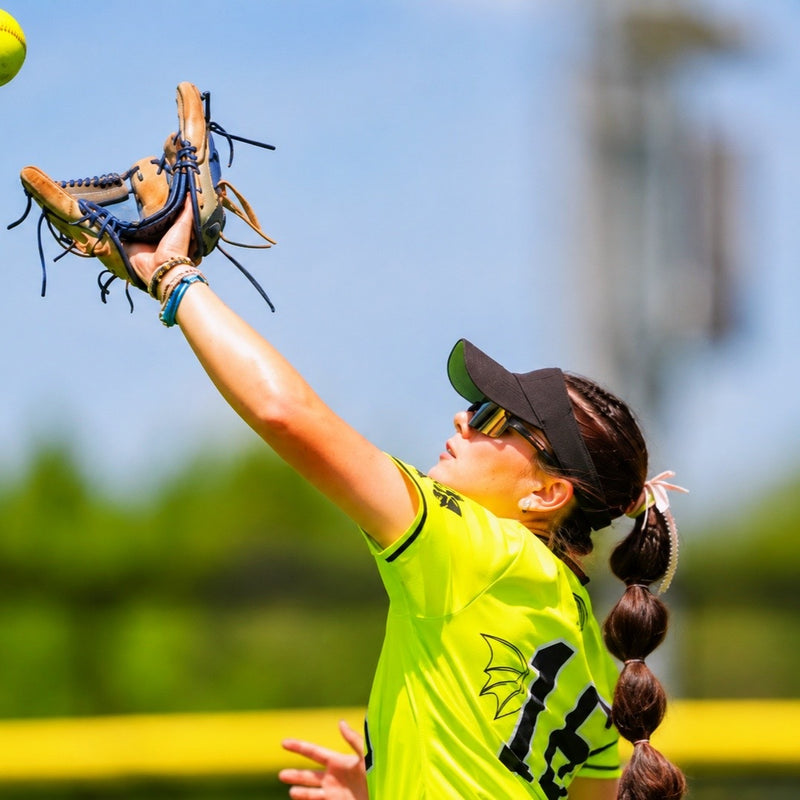 softball player catches ball while wearing black gold Solaro Shades - the leading choice for baseball sunglasses and sports sunglasses and running sunglasses.