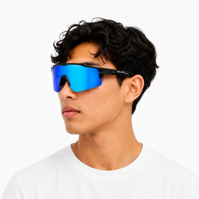 A man wearing solaro shades sunglasses with a black frame and vibrant blue mirrored lenses, shown in profile against a plain white background.