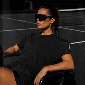 Female athlete wearing Blackout Cosmo baseball sunglasses by Solaro Shades while playing sports.