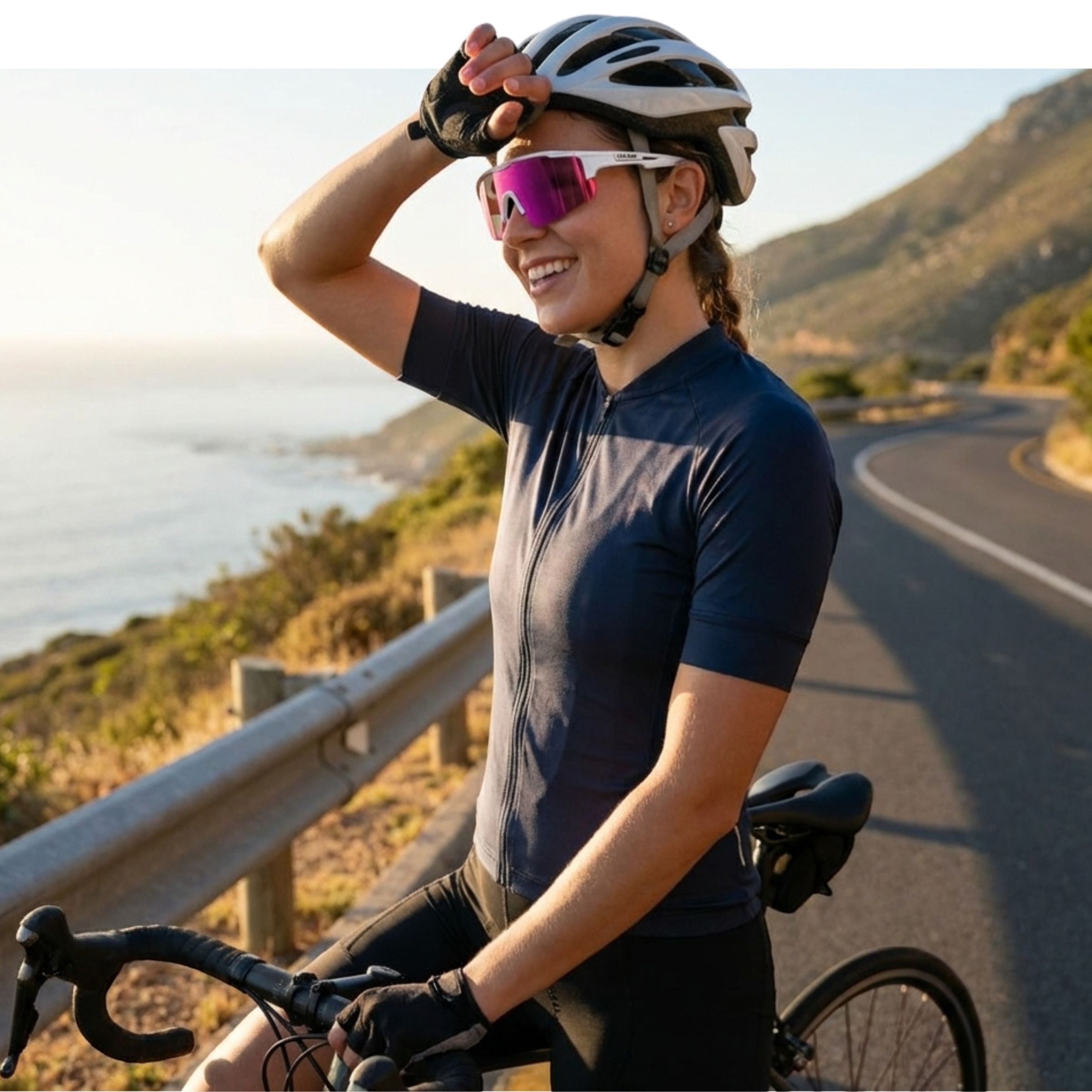 Cyclist on a road with mountains and ocean in the background wearing Solaro Shades cycling sunglasses