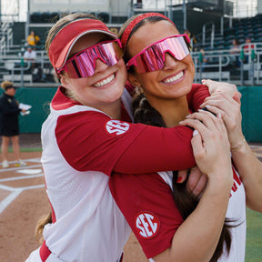Ramsey Walker and Kailey Wyckoff of Arkansas softball wearing the hot pink Solaro Shades. 