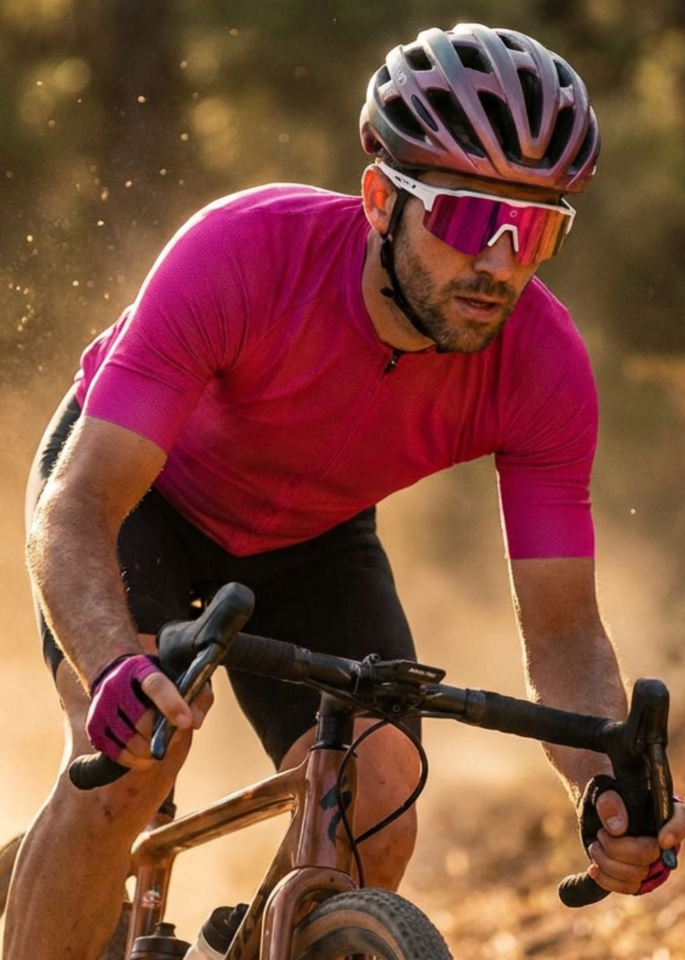 Cyclist in a pink jersey and helmet riding on a dirt road wearing Solaro Shades cycling sunglasses