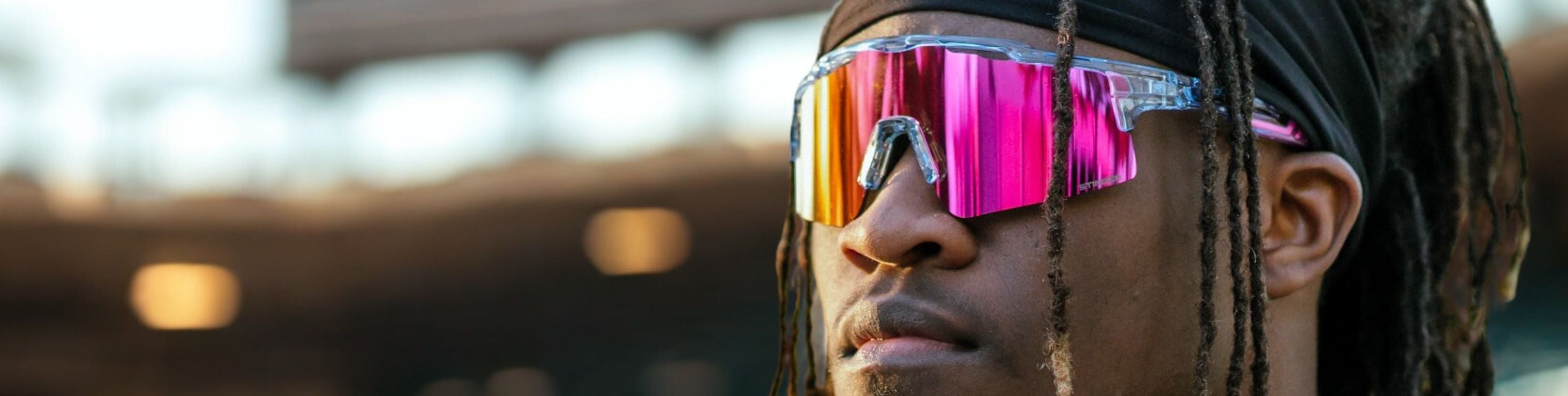 Person wearing colorful reflective Solaro Shades sports sunglasses with a blurred background
