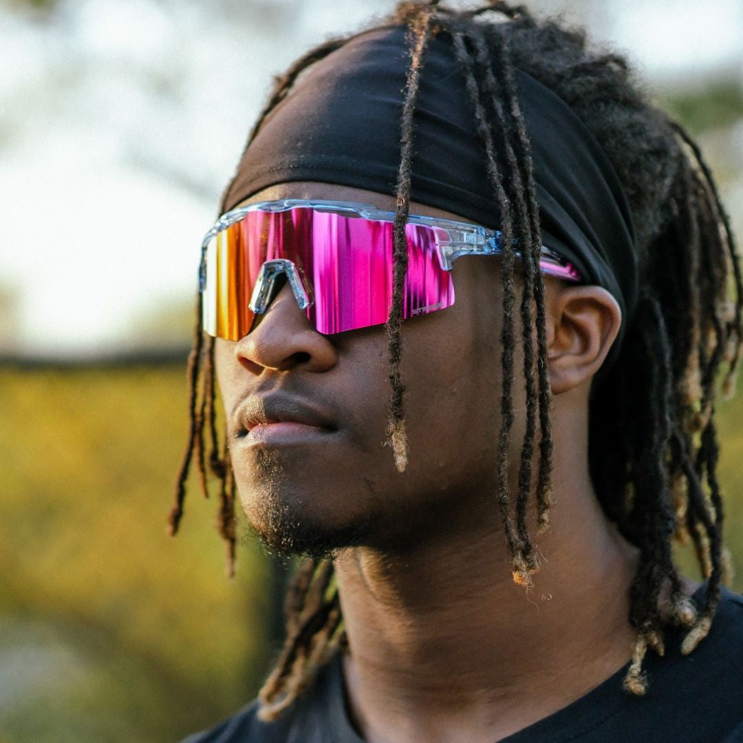 Person wearing colorful reflective Solaro Shades sports sunglasses with a blurred background