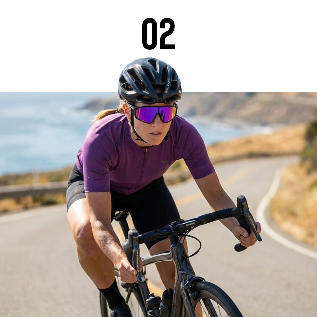 Person cycling on a road with a scenic background wearing Solaro Shades cycling sunglasses