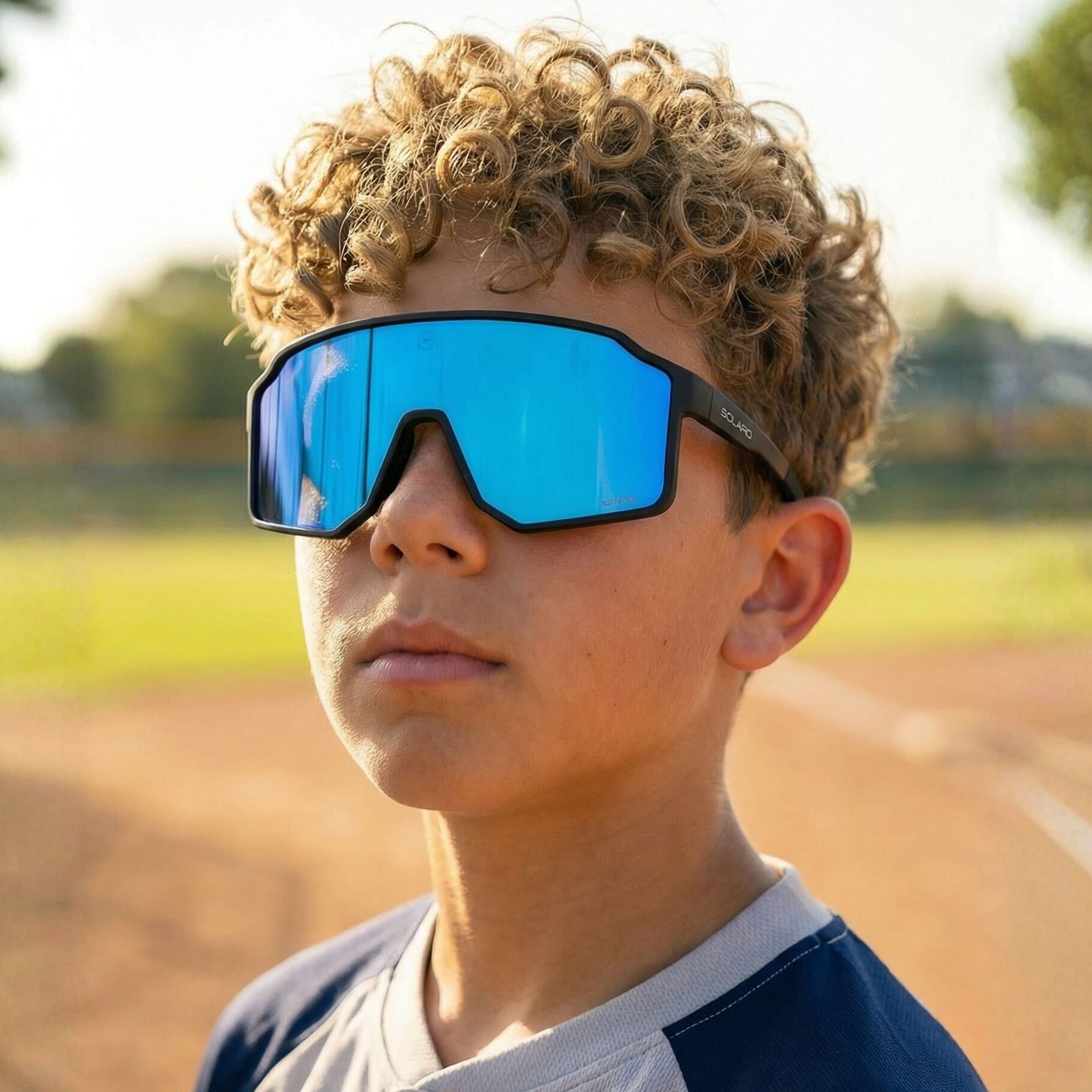 Young athlete wearing Solaro Shades youth sports sunglasses for baseball. 