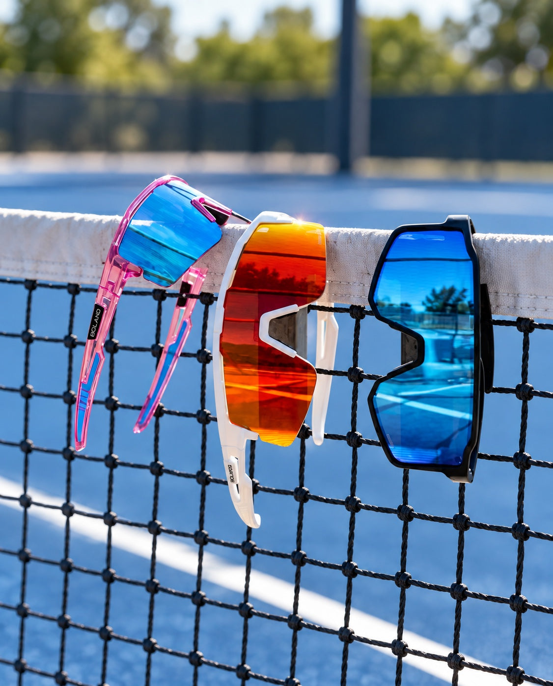 Three pairs of Solaro sunglasses hanging on a tennis net