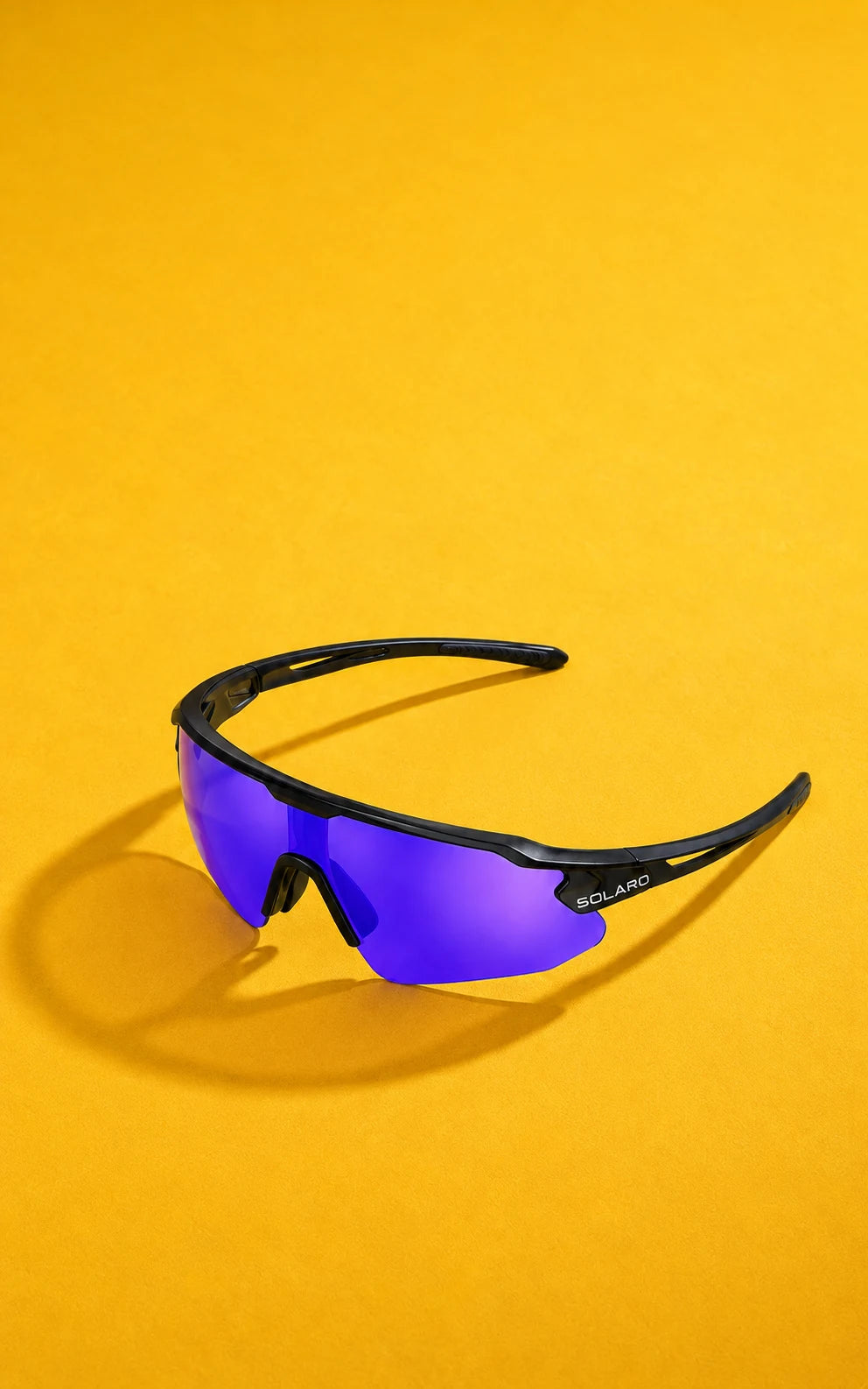 Black Solaro sunglasses with purple lenses on a golden yellow background