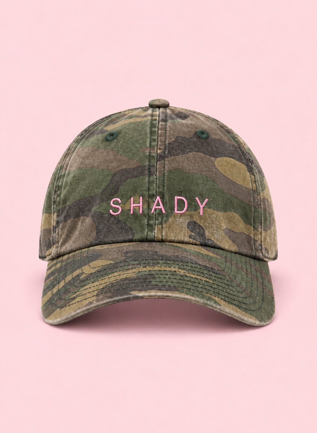 Shady camo hat with pink embroidery on a pink background