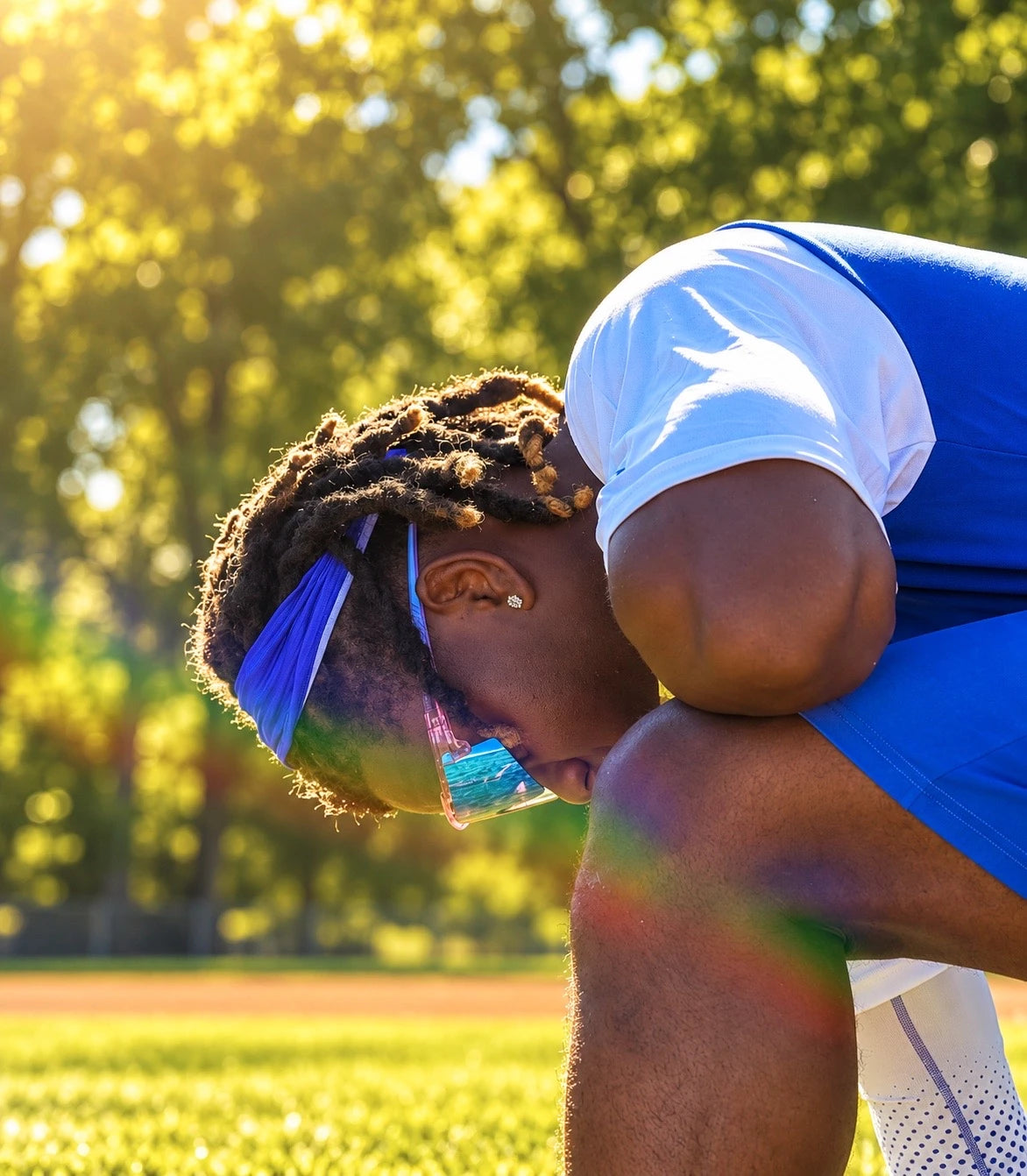 Athlete wearing pink Solaro sunglasses with blue mirrored lenses in warm sunlight